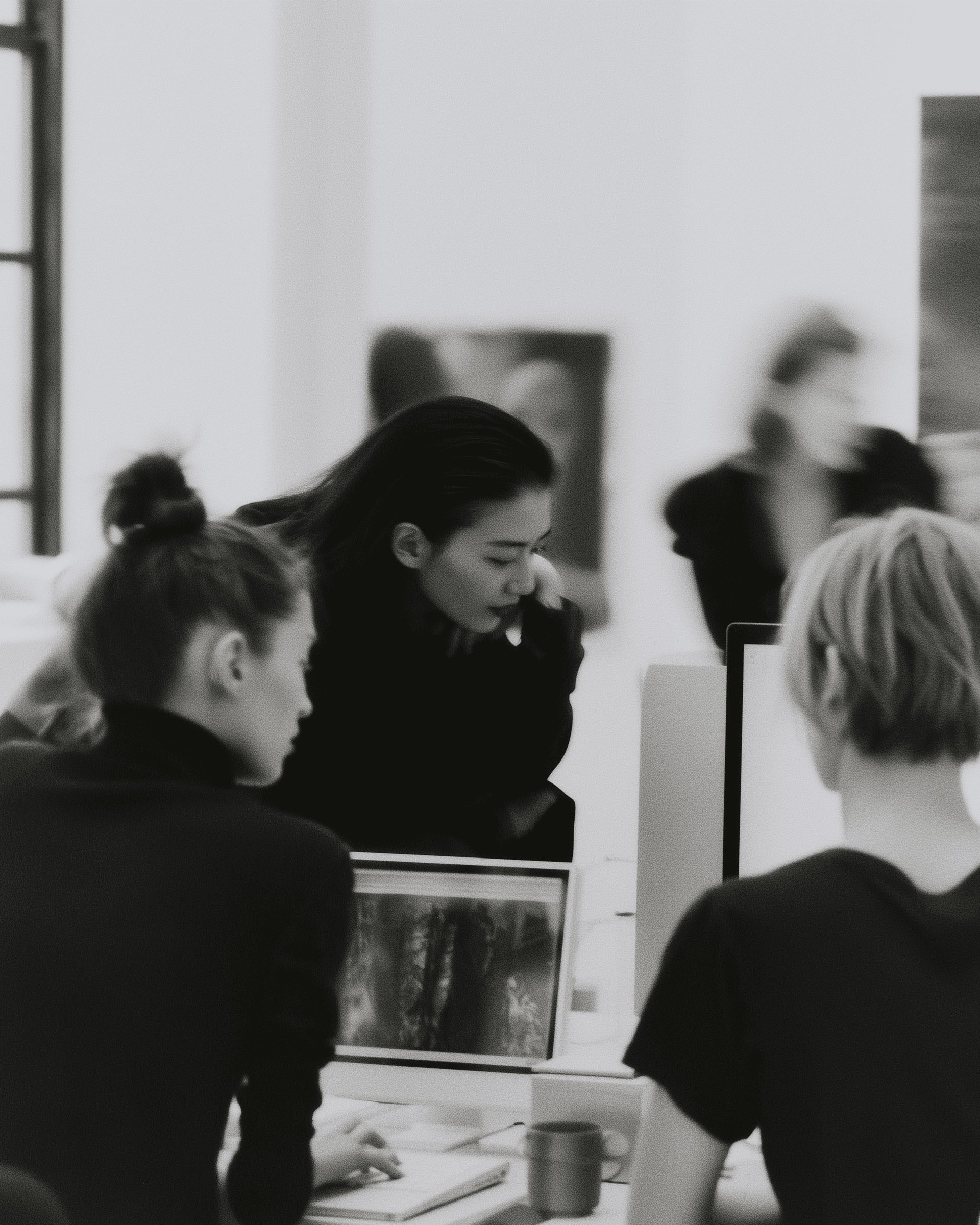 Black-and-white photograph of a team working together in a studio
